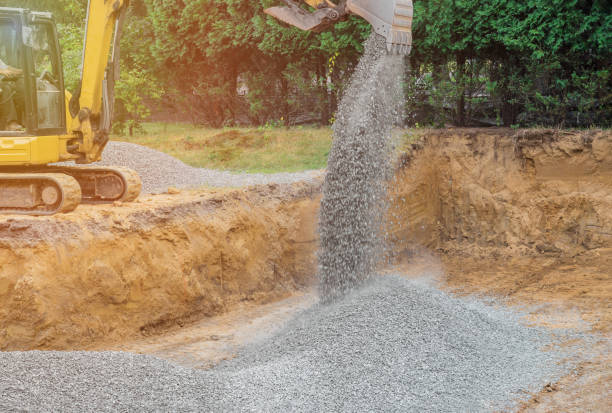 istock Excavator digging bucket scooping gravel from a building foundation 1196717987