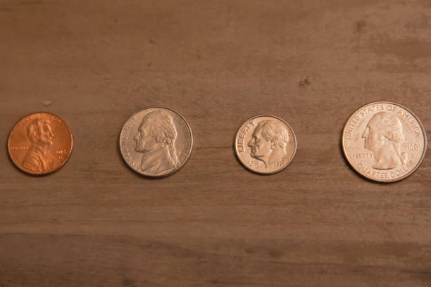 A penny on the curb near the road.