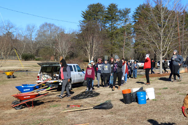 Student volunteers arriving to plant trees for 2019 MLK Day of Service in Winterville, Georgia. Winterville, Georgia - January 21, 2019: Student volunteers participating in the MLK Day of Service arrive to help plant trees at the Winterville Elementary School. martin luther king jr day stock pictures, royalty-free photos & images