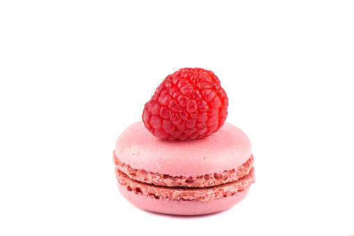 Pink macaroon with raspberry isolated on a white background. Sweet macaroons. French dessert - macaroons.