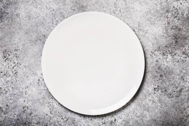 istock White ceramic tray on a table with concrete texture, top view. Food background 1196723243
