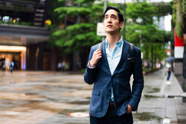Businessman in rain in city