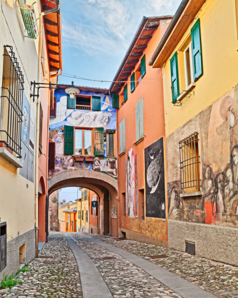 Dozza, Bologna, Italy: street with paintings on the walls Dozza, Bologna, Emilia Romagna, Italy: street with paintings in the ancient town where every two years takes place the festival of the painted wall and famous artists paint works on the walls of the houses. February 28, 2015 medieval fresco stock pictures, royalty-free photos & images