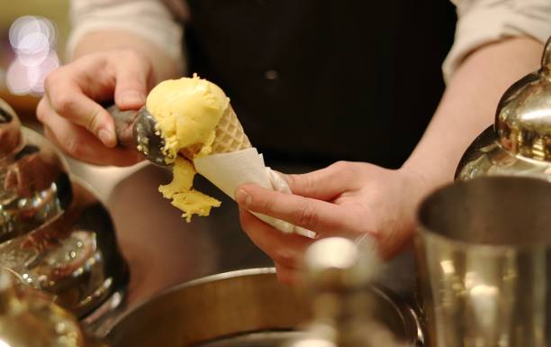 istock the salesman puts the ice cream in a waffle Cup 1196728340