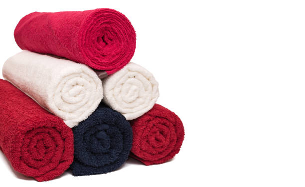 istock Stack of rolled clean soft bath towels on white background. Closeup. Copy space 1196728412