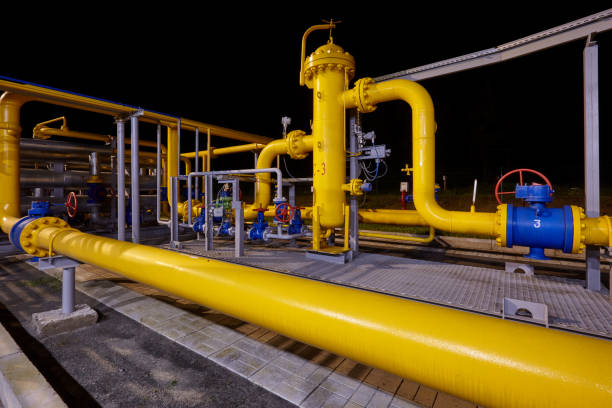 istock Pipeline system at a gas production and processing plant. Pipes, valves, manometers. Night shooting 1196736772