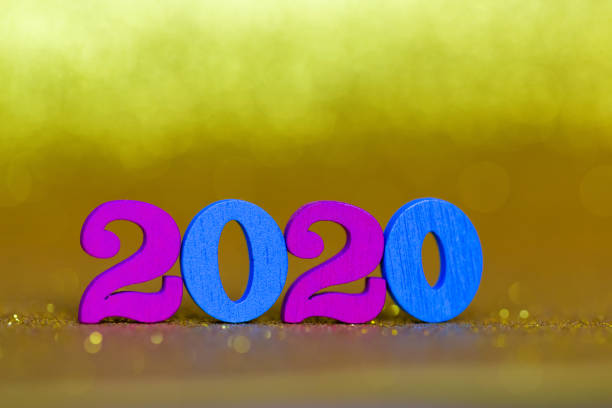 istock Wooden numbers 2020 on a golden background 1196739690