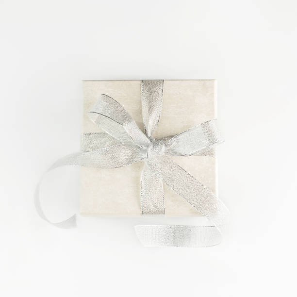 istock Beautiful present box with elegant silver bow on white background. Festive backdrop for your holiday design. Flat lay style. 1196740558