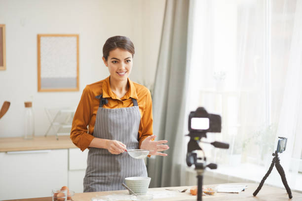 istock Beautiful Woman Filming Baking Video 1196741078