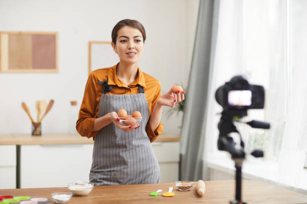 istock Woman Filming Cooking Video 1196741086