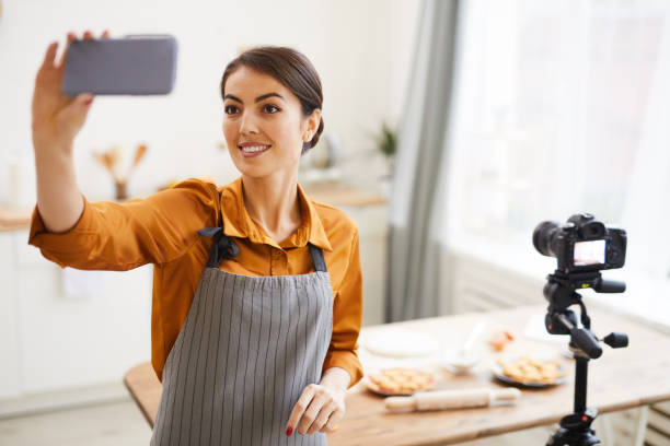 istock Smiling Woman Vlogging in Kitchen 1196741093