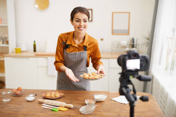 istock Young Woman Filming Baking Video in Kitchen 1196741095