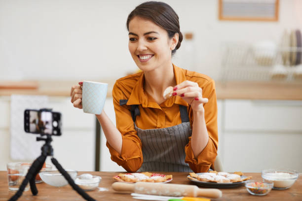 istock Young Woman Filming in Cozy kitchen 1196741126