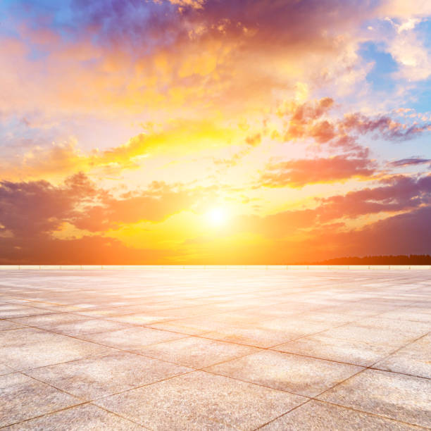 istock Tiled pavement plazas terrace skyline and sunset sky clouds. 1196745597