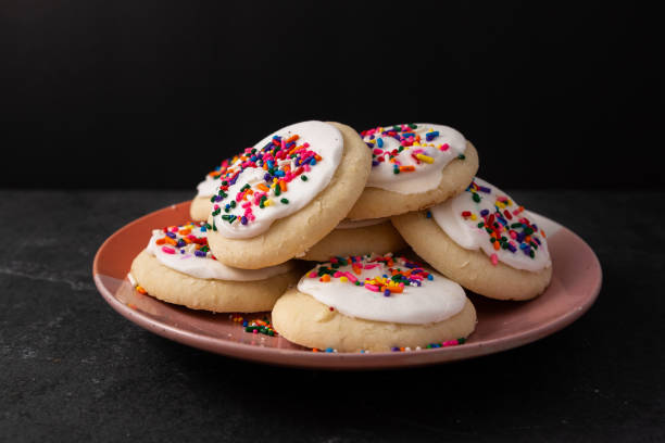 Sprinkle cookies with vanilla icing Sprinkle cookies with vanilla icing icing stock pictures, royalty-free photos & images