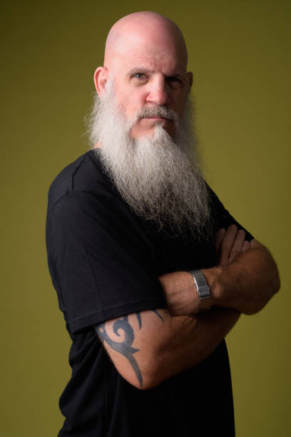 istock Angry mature bald man with long gray beard crossing arms 1196751918