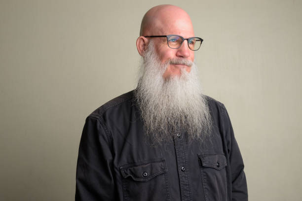 istock Mature bald man with long gray beard thinking and wearing eyeglasses 1196751983