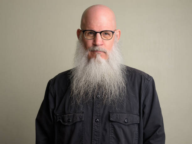 istock Mature bald man with long gray beard wearing eyeglasses 1196751985