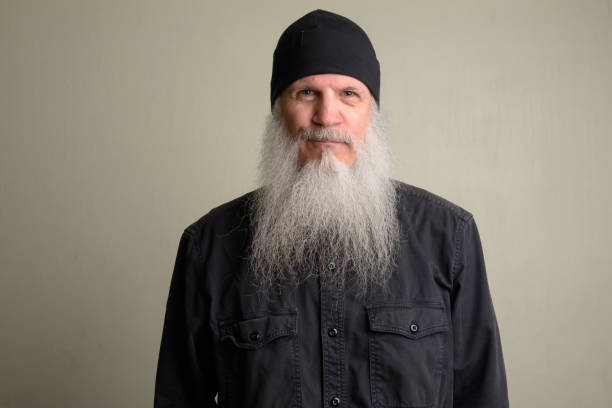 istock Mature man with long gray beard wearing beanie hat 1196751986