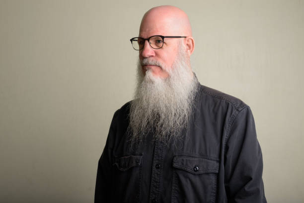 istock Mature bald man with long gray beard thinking and wearing eyeglasses 1196751989