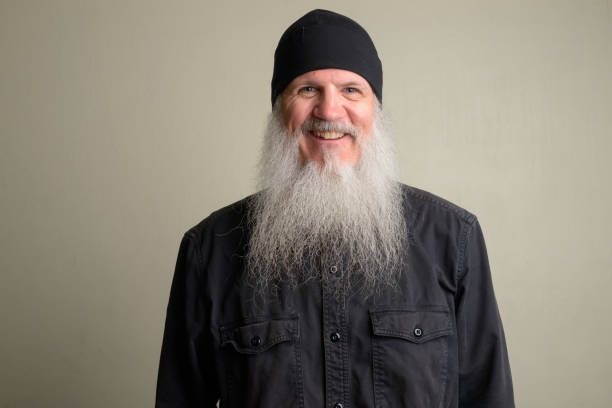 istock Happy mature man with long gray beard wearing beanie hat 1196751992