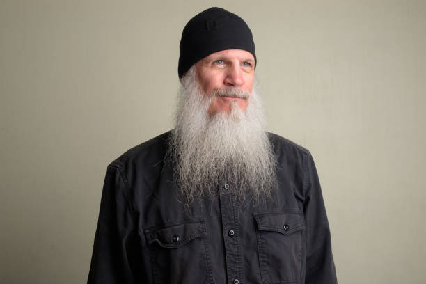 istock Mature man with long gray beard thinking and wearing beanie hat 1196751997
