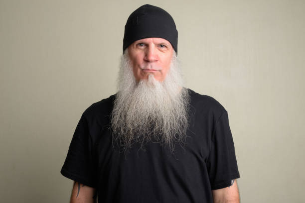 istock Serious mature man with long gray beard wearing beanie hat 1196752005