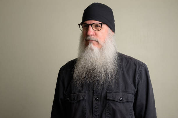 istock Mature man with long gray beard thinking and wearing eyeglasses 1196752009