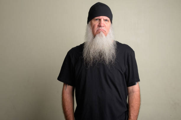 istock Angry mature man with long gray beard wearing beanie hat 1196752553