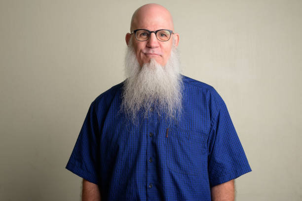 istock Mature bald man with long gray beard wearing eyeglasses 1196752584