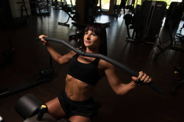 istock Beautiful Woman Doing Heavy Weight Exercise For Back 1196754051