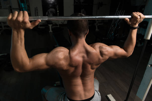 istock Shulder Exercise With Barbell In Gym 1196754081