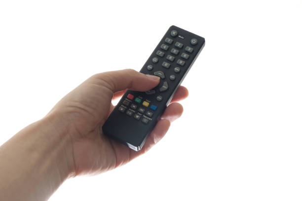 istock His hand is holding the remote control and operate the remote control. on the White Background . Concept of Technology 1196754105