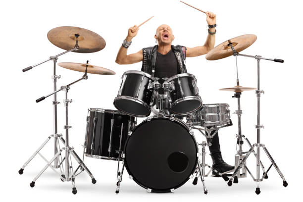 Male musician in leather vest playing a drum kit Male musician in leather vest playing a drum kit isolated on white background drummer stock pictures, royalty-free photos & images