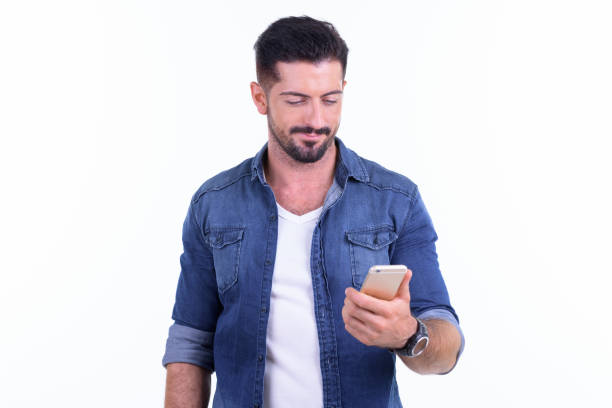 istock Young handsome bearded hipster man using phone 1196754296