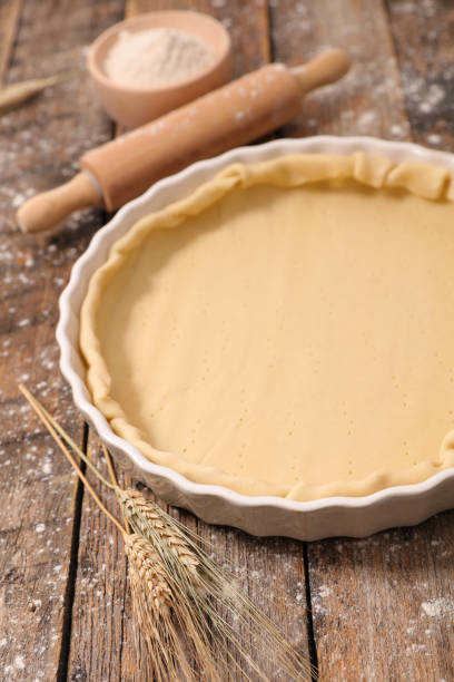 istock raw dough with rolling pin and flour 1196754304
