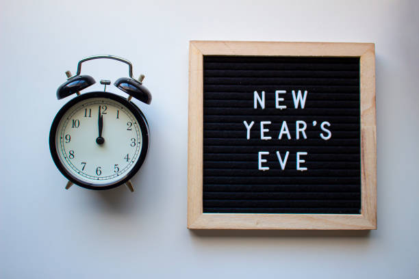 istock New Year's Eve board with a Clock at 12 1196755731