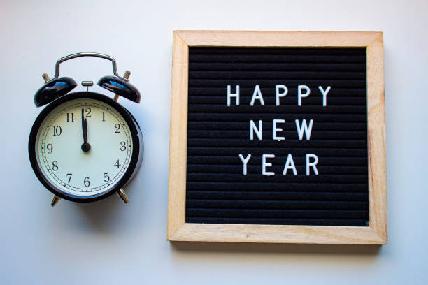 istock Happy New Year board with a Clock at 12 1196755744