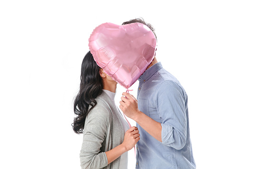 Romantic couples holding a heart-shaped balloons