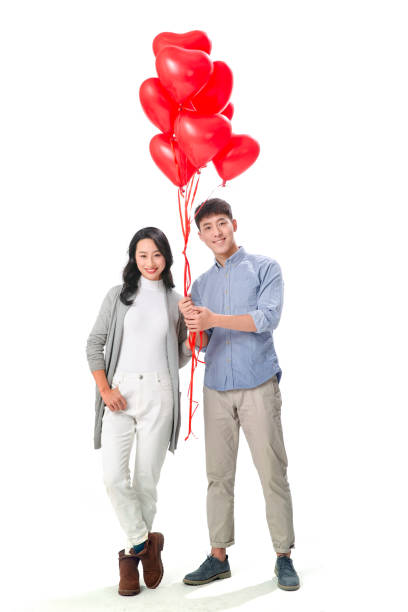 istock Romantic couples holding a heart-shaped balloons 1196761150