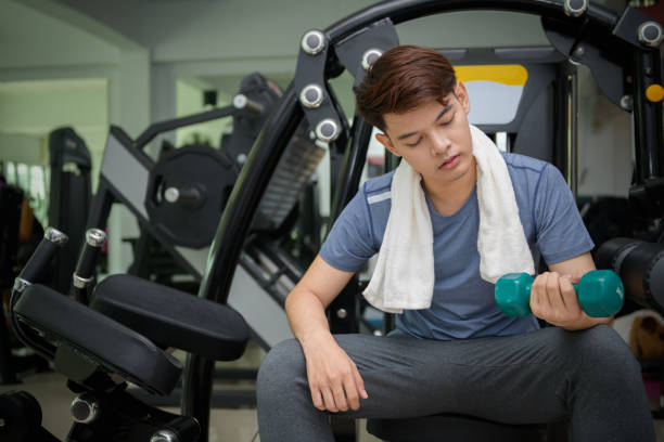 istock Handsome asian man lifting dumbbells 1196766033