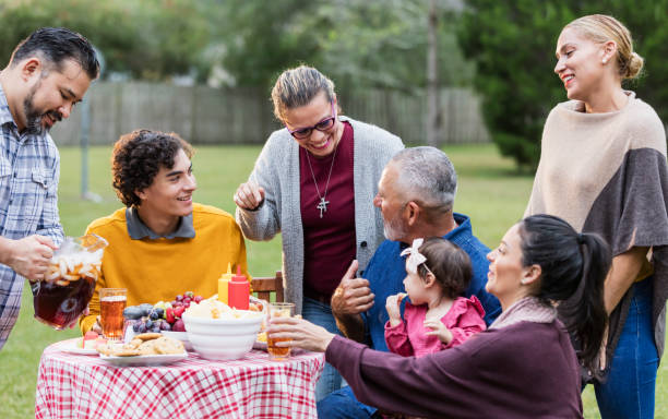 istock Multi-generation Hispanic family having backyard cookout 1196769010