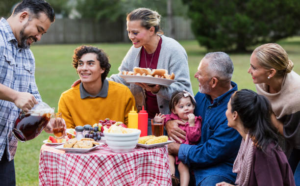 istock Multi-generation Hispanic family having backyard cookout 1196769537