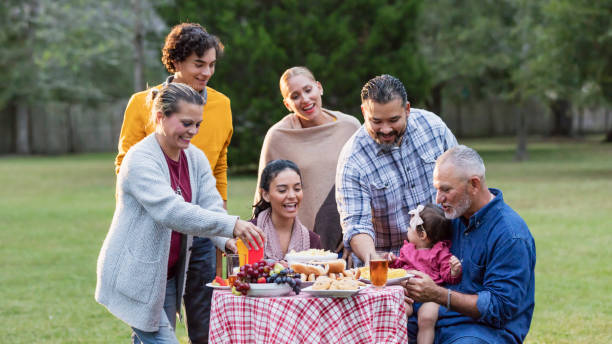 istock Multi-generation Hispanic family having backyard cookout 1196769565