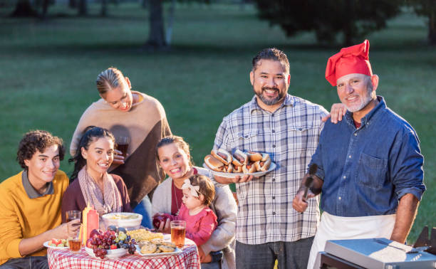istock Multi-generation Hispanic family having backyard cookout 1196769566