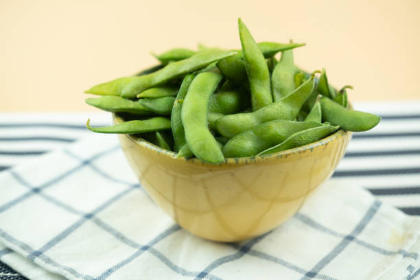 istock Boiled Edamame bean or young green soybean in yellow bowl 1196770577