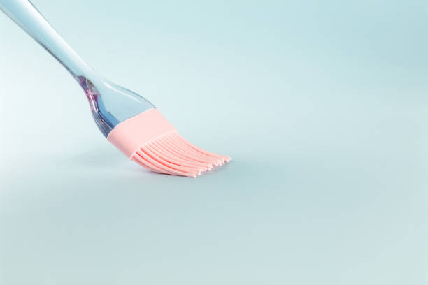 istock Pink silicone brush on light blue background, close up, copy space 1196771240