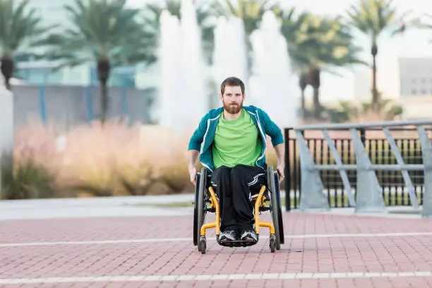 Photo of Man with cerebral palsy in self-propelled wheelchair
