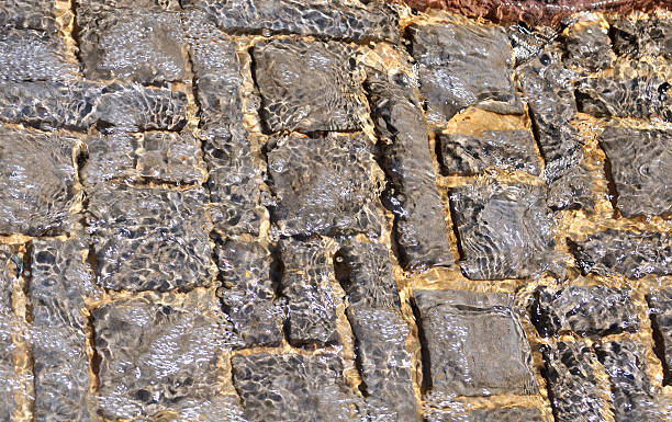 Rippled water texture over stones stock photo