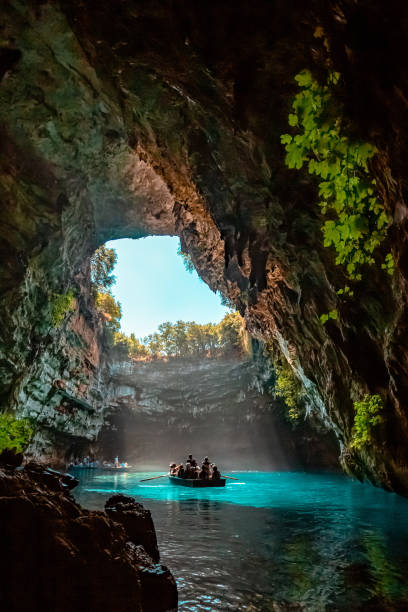Lake Cave Melissani is a cave with its roof caved in many years ago. The cave in has caused water to come in and create a tepid lake. The colors are brilliant with the crystal clear waters. The open part of the cave gives you fantastic views from the boat all the way up to the sky. kefalonia stock pictures, royalty-free photos & images